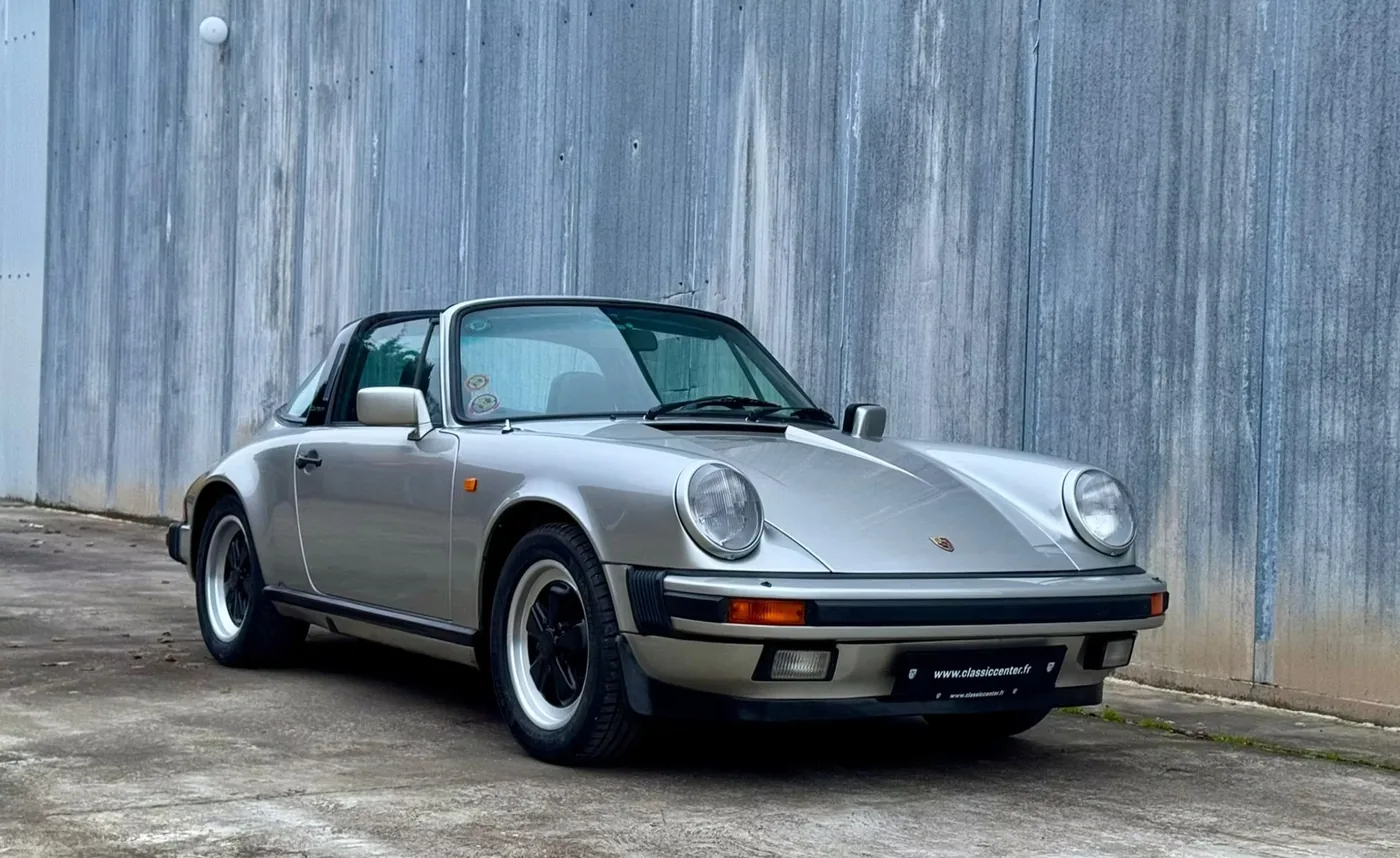 Silver Porsche 911 Targa in front of a metal wall